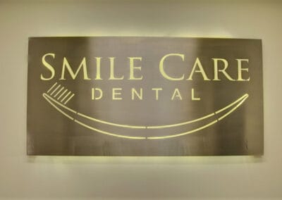Smile Care Dental Center sign behind front desk